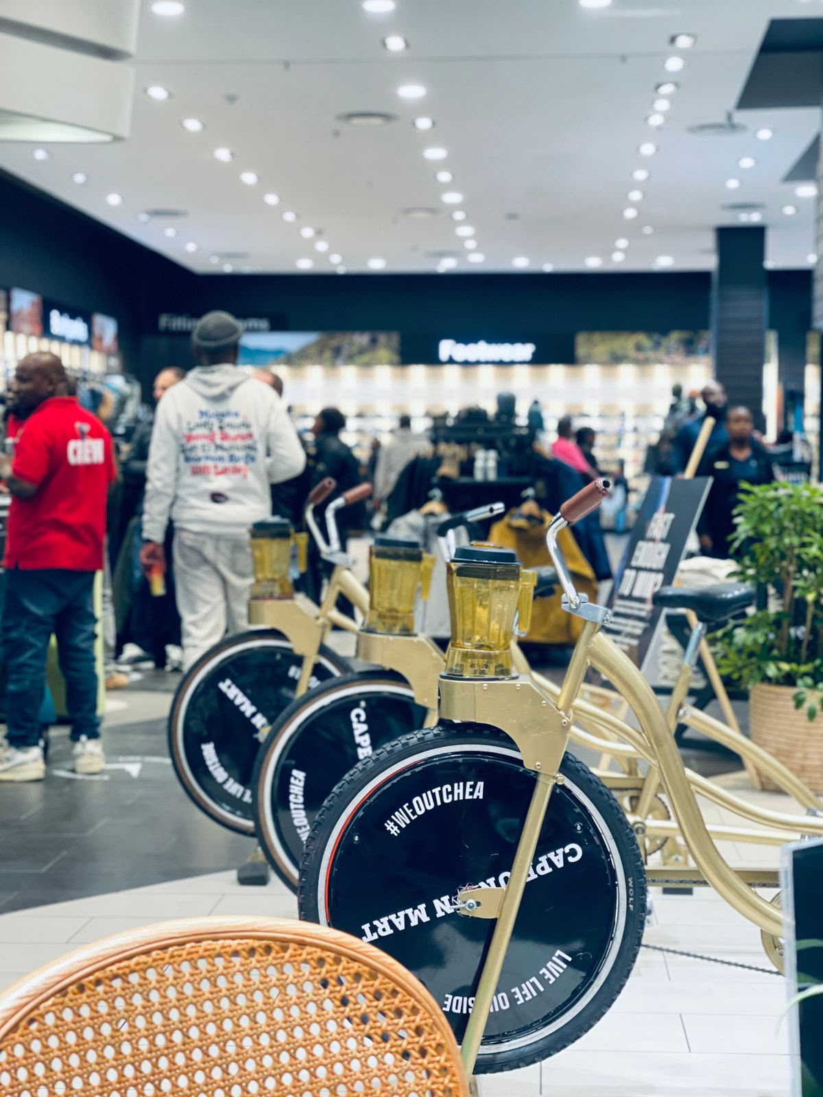 Fleet of gold smoothie bikes lined up at an in-store activation